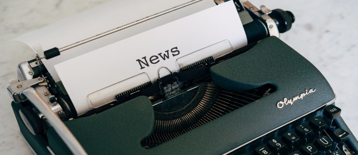 Typewriter with a sheet of paper stating "news"