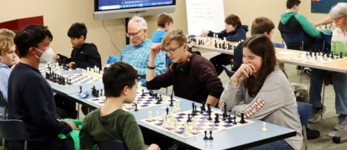 Chess Club with kids and adult club mentors playing chess